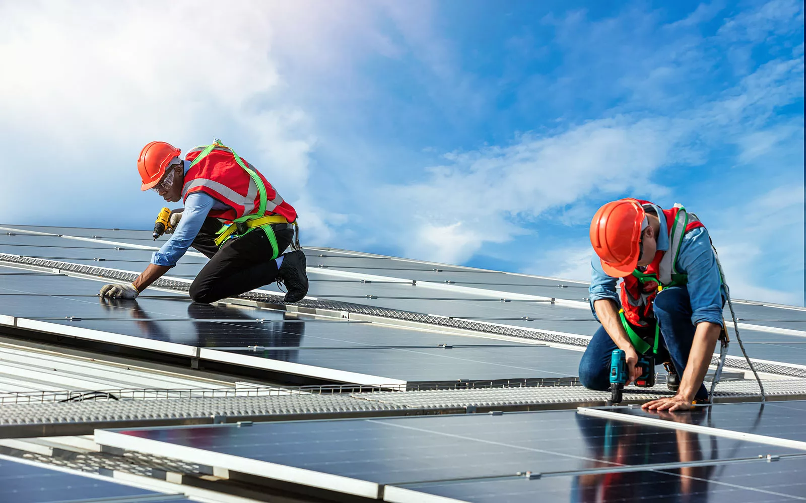 Engineers installing solar panels on the roof